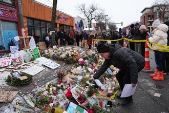 People visit a makeshift memorial for Alex Pretti on Jan. 26, 2026, in Minneapolis.