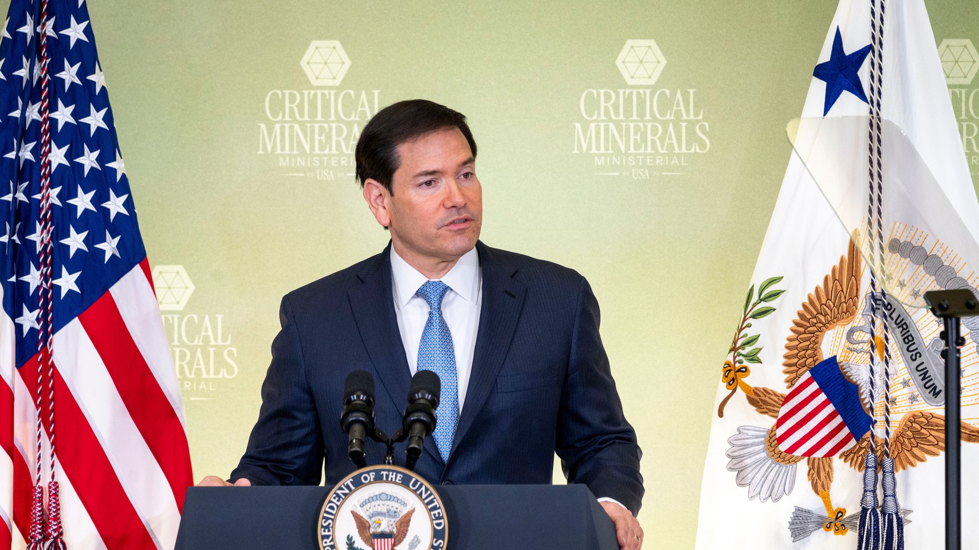 Secretary of State Marco Rubio stands at a podium.