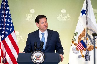 Secretary of State Marco Rubio stands at a podium.