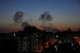 Plumes of smoke rise into the night sky over buildings in Tehran, Iran, as strikes hit the city during the U.S.–Israeli military campaign on March 6, 2026