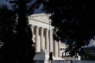 The Supreme Court, partially obscured by trees.