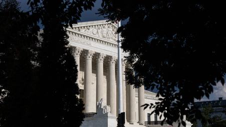 The Supreme Court, partially obscured by trees.