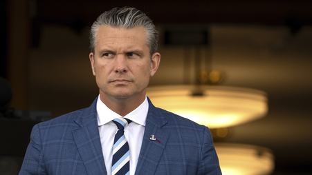Defense Secretary Pete Hegseth is pictured, with his eyes looking sideways.