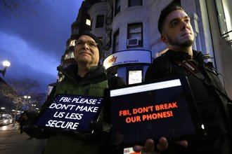 Demonstrators protest the FBI obtaining a court order that requires Apple to make it easier to unlock an encrypted iPhone - AP482176664256
