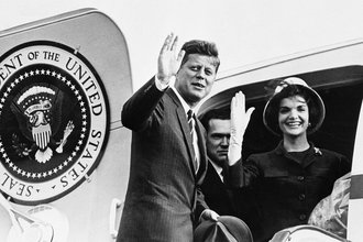 President John Kennedy and Jacqueline Kennedy wave goodbye from door of presidential plane as they prepare to leave Vienna June 4, 1961
