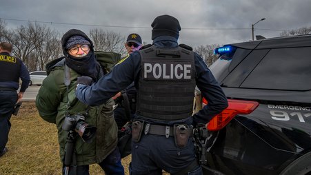 Freelance photojournalist Matthew Kaplan, at center left in green, was the first journalist known to be arrested this year, when he was detained covering an anti-deportation protest in Gary, Indiana, on Jan. 18, 2025.