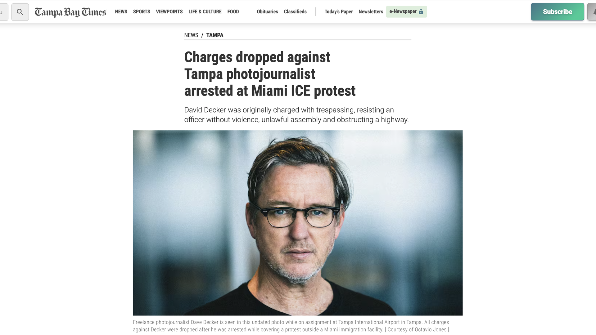 Screenshot of Tampa Bay Times article headlined "Charges dropped against Tampa photojournalist arrested at Miami ICE protest" with headshot of Decker.