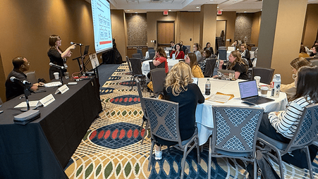 FPF’s Davis Erin Anderson, standing at left, presents at a national Education Writers Association meeting in May 2025.