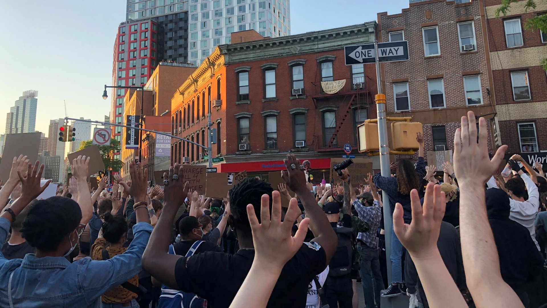 Protestors at a George Floyd action in Brooklyn raise their hands