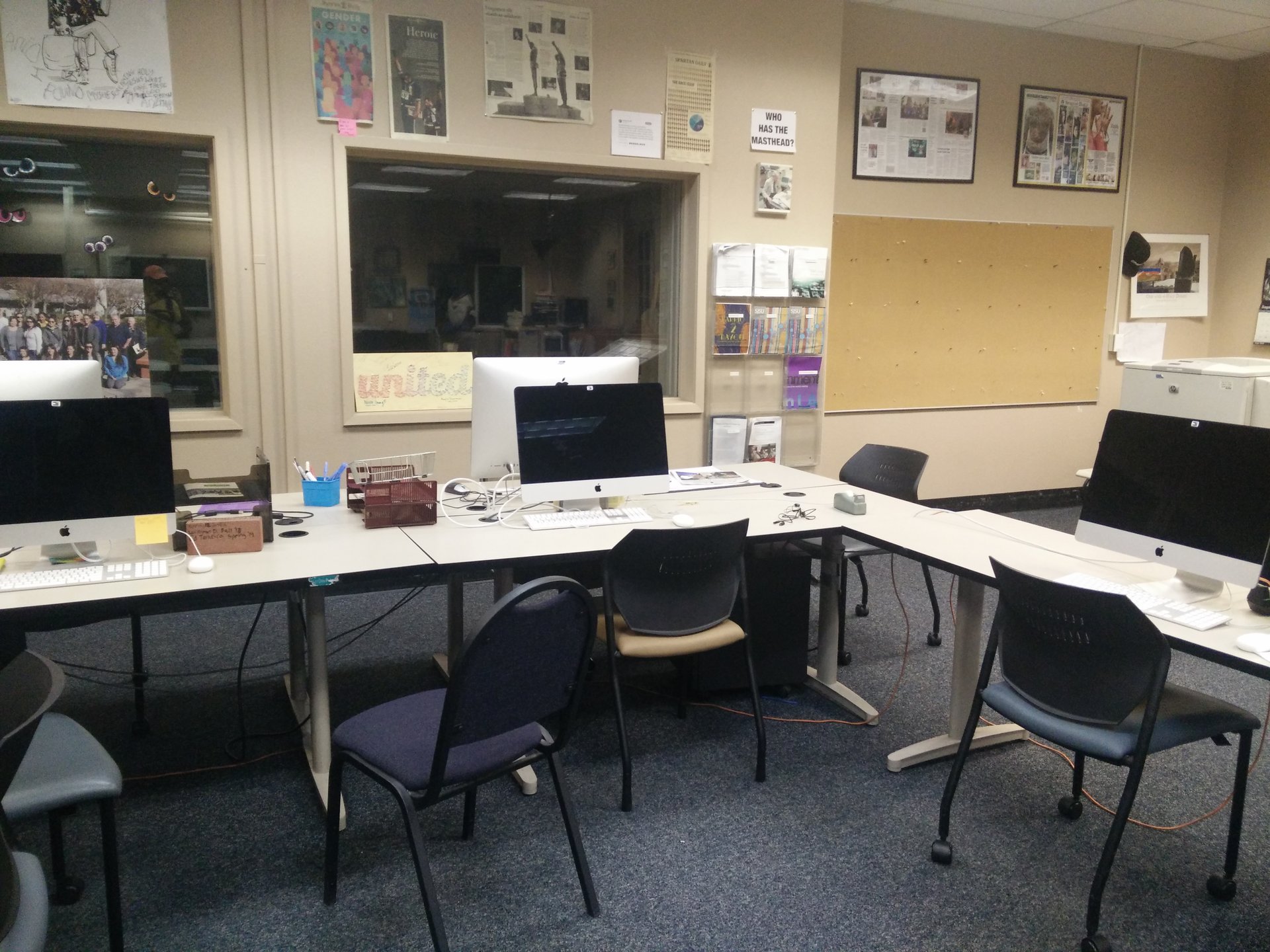Image showing student newsroom desktop computers, complete with Freedom of the Press Foundation webcam stickers.