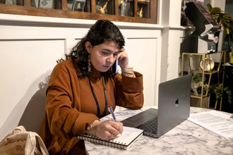 San José Spotlight City Hall reporter Jana Kadah conducts a phone interview