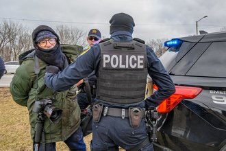 Freelance photojournalist Matthew Kaplan, at center left in green, was arrested while covering an anti-deportation protest in Gary, Indiana, on Jan. 18, 2025.