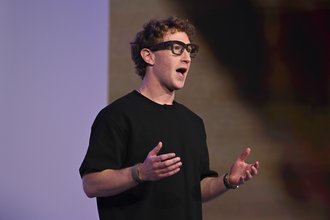 Mark Zuckerberg speaks at a conference while wearing smart glasses.