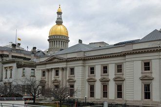 A multi-wing government building capped with a gold rotunda