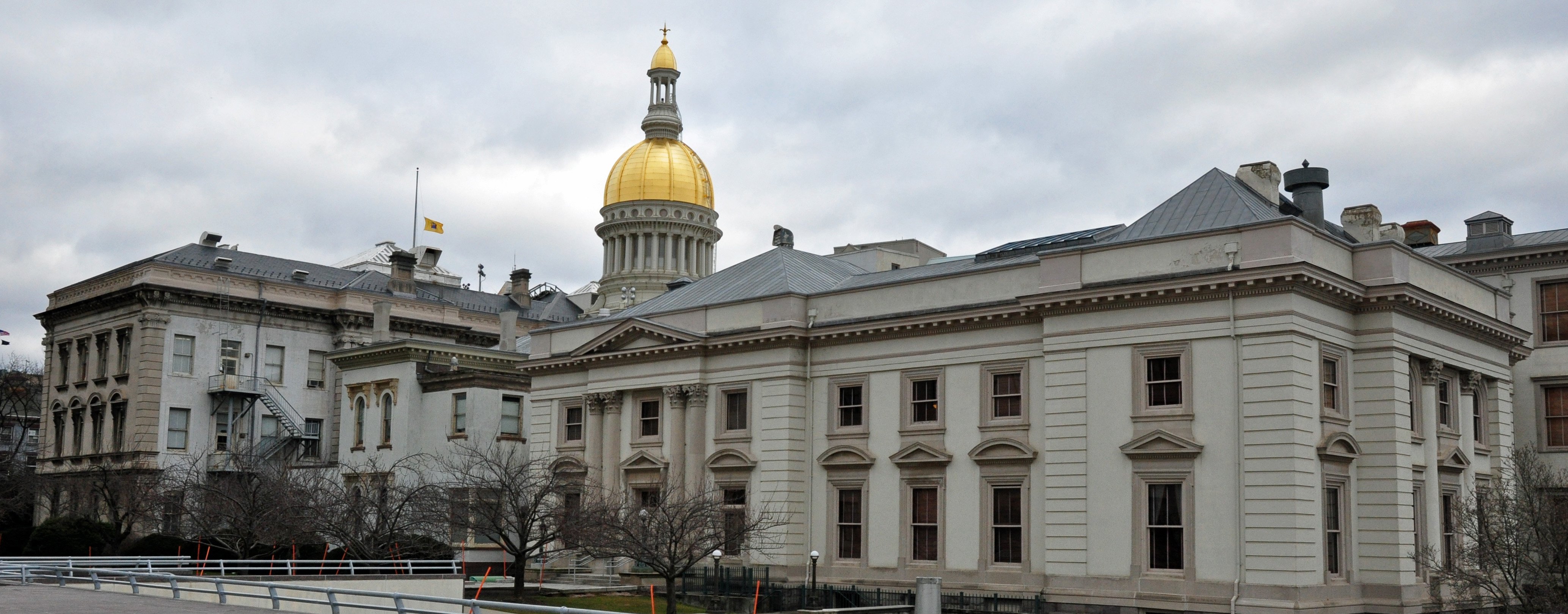 A multi-wing government building capped with a gold rotunda