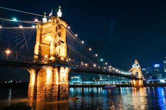 Roebling Suspension Bridge connecting Cincinnati, Ohio, and Covington, Kentucky, pictured at night.