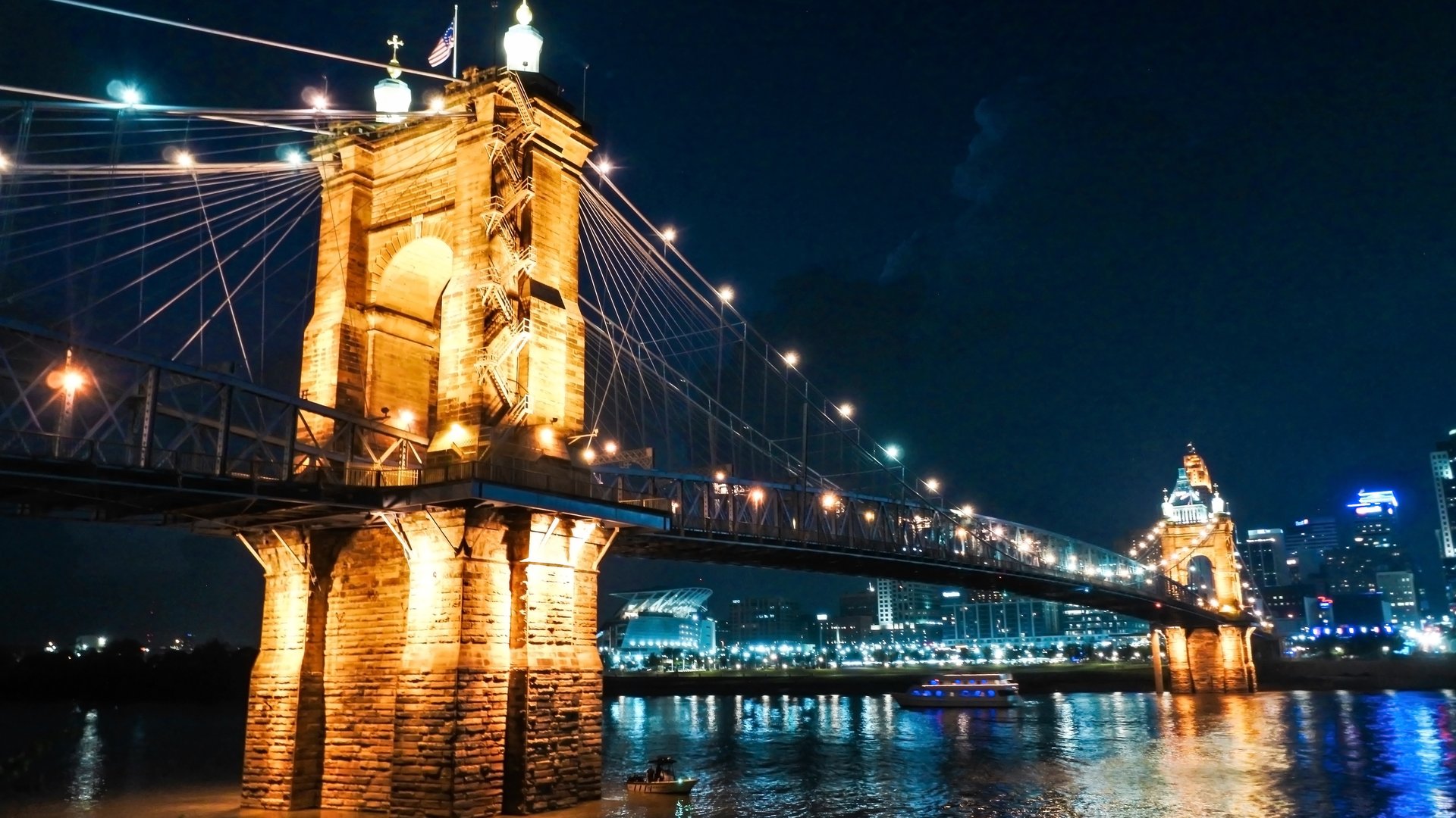 Roebling Suspension Bridge connecting Cincinnati, Ohio, and Covington, Kentucky, pictured at night.