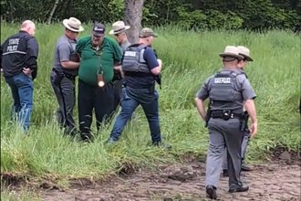 Journalist Isaac White being handcuffed while documenting a land claim demonstration in northern New York on May 21, 2024.