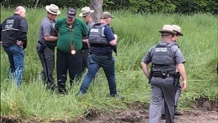 Journalist Isaac White being handcuffed while documenting a land claim demonstration in northern New York on May 21, 2024.