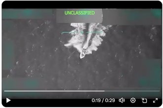 A screenshot of a video of a U.S. military strike on a boat with the word “unclassified” at the top.