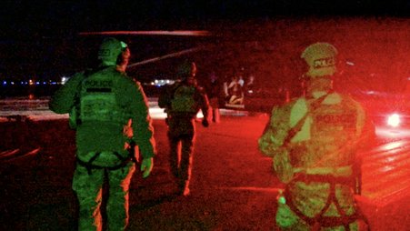ICE Homeland Security Investigations (HSI) agents boarding a plane with Customs and Border Protection to provide security during Super Bowl 52.
