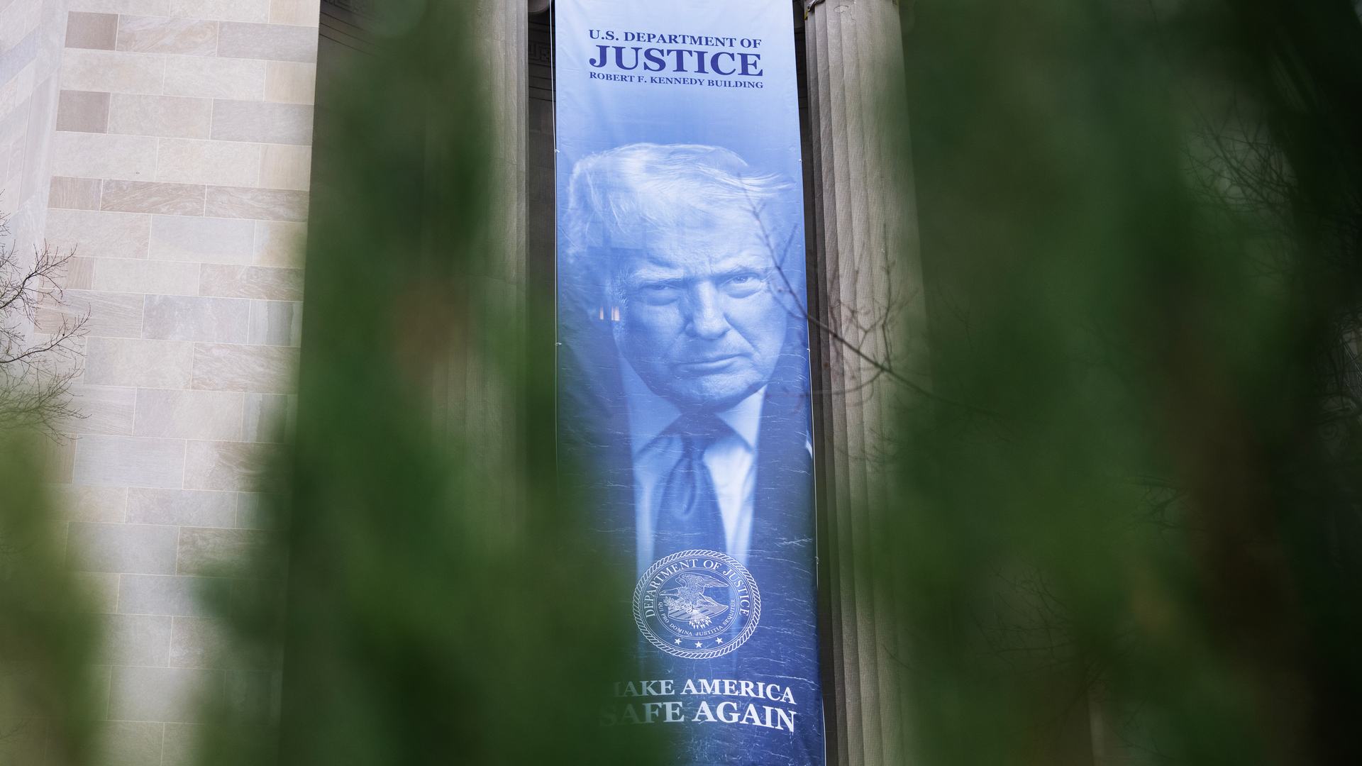 A banner depicting President Donald Trump hangs along Pennsylvania Avenue, NW, on the Department of Justice building on Monday, Feb. 23, 2026