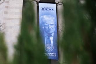 A banner depicting President Donald Trump hangs along Pennsylvania Avenue, NW, on the Department of Justice building on Monday, Feb. 23, 2026