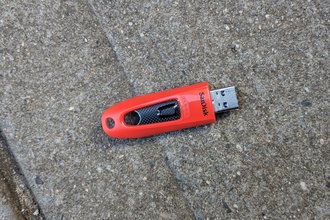 Photo of a SanDisk USB drive on the ground