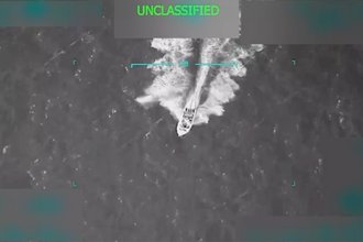 A screenshot of a video of a U.S. military strike on a boat with the word “unclassified” at the top.