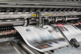 Newspaper coming off a press