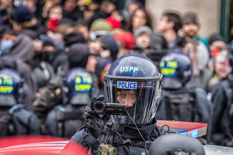 Law enforcement officer films protesters at a J20 protest in DC