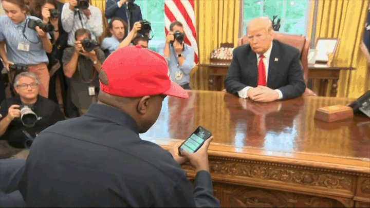 An animation zooming into Kanye West's iPhone as he types in his password, which is apparently "000000." His phone unlocks.