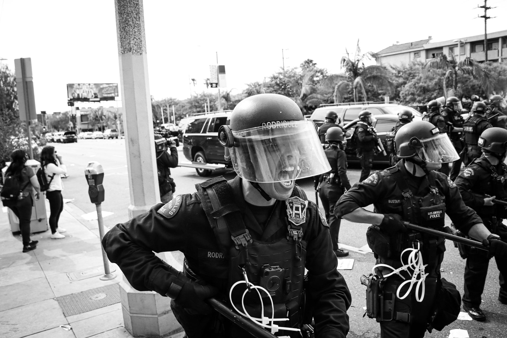 Los Angeles police officer pushing back protesting crowds