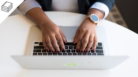 Header image of a woman typing on her computer