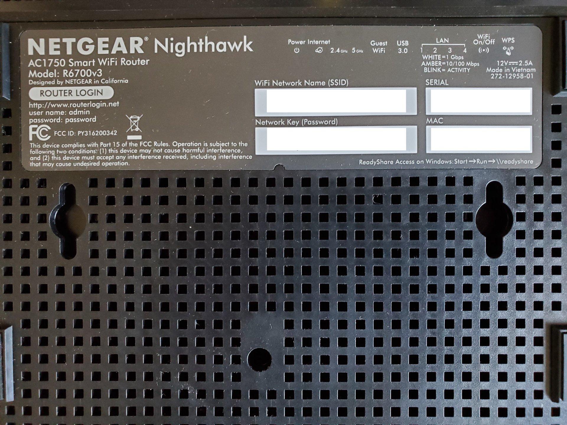 Photo of a sticker on the bottom of a router, displaying its security information.