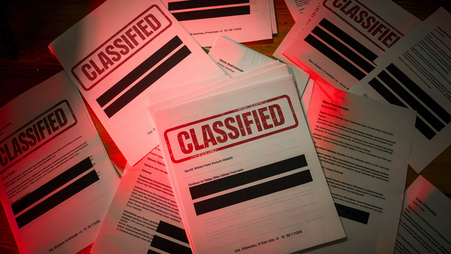 A pile of classified redacted documents