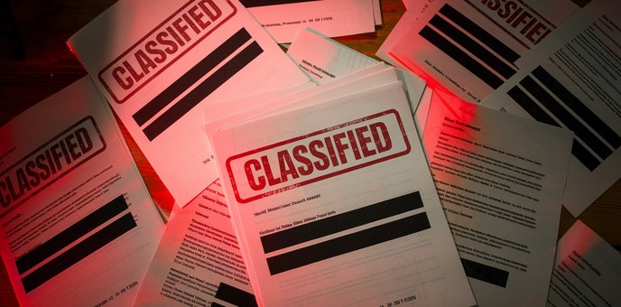 A pile of classified redacted documents