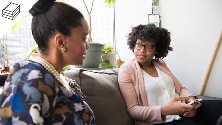 Header image of two women speaking to each other on a couch